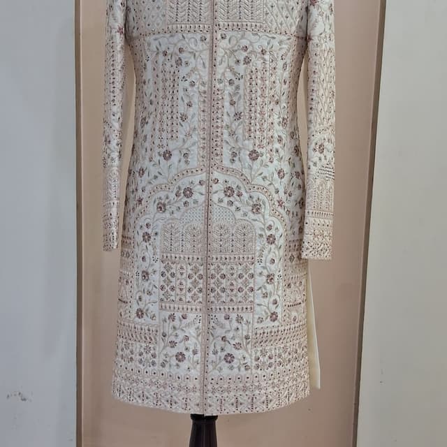 Off-white base with metallic gold and rose gold embroidery accents Sherwani