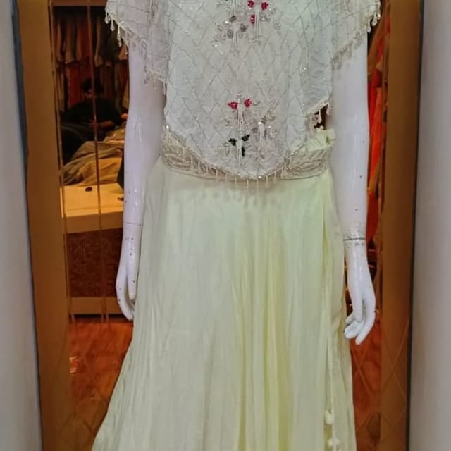 Pastel yellow, white, metallic silver, with hints of red and green embroidery Lehenga Choli