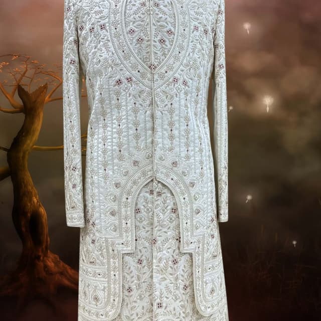 Off-white or cream with subtle maroon or deep red accent beadwork Sherwani