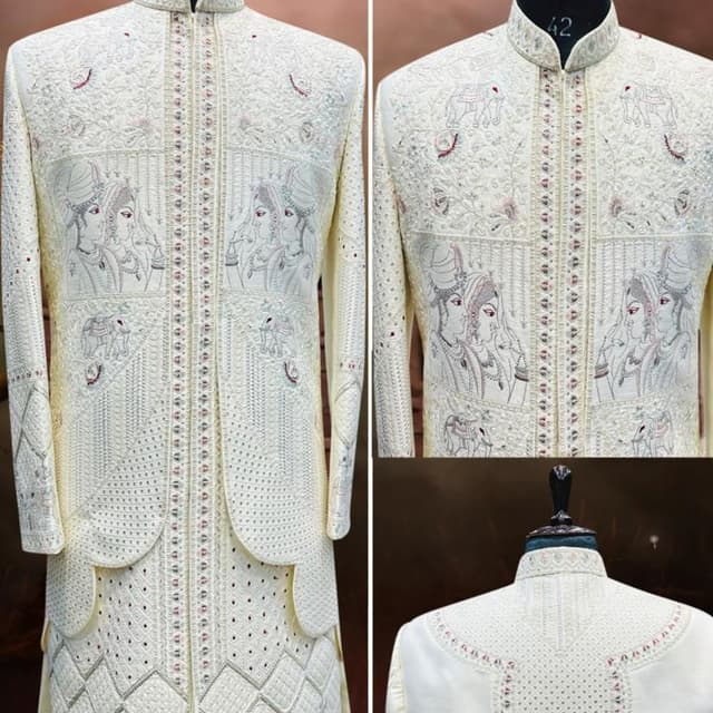 Off-white or cream base with subtle silver, grey, and hints of red embroidery Sherwani