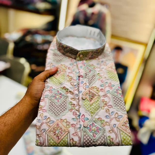 Pastel pink base with multi-colored thread work including green, blue, and peach Kurta