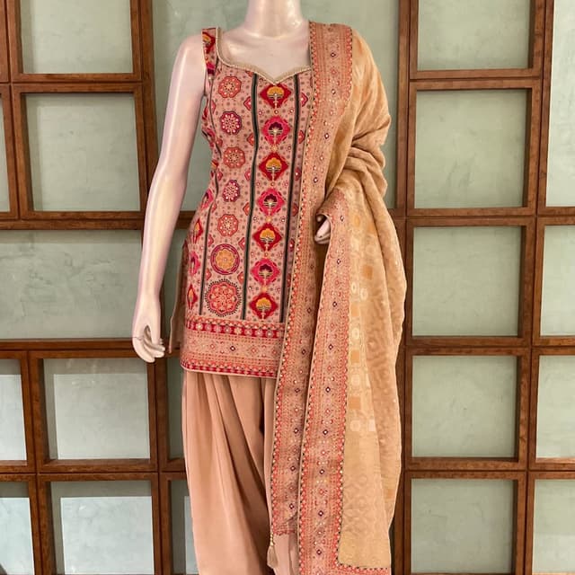 Beige base with vibrant pink, red, yellow, and green accents Salwar Kameez suit with dupatta
