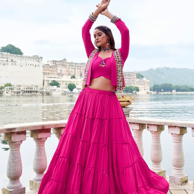 Hot pink monochromatic base with multi-colored border embellishments Lehenga Choli with Jacket
