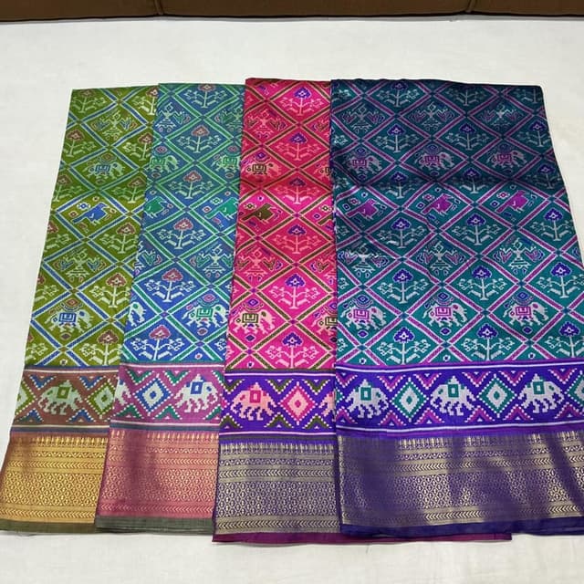 Vibrant and varied, including shades of pink, blue, green, and purple, with accents of gold. Saree